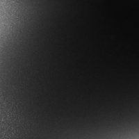 Texture of black hard steel in the dark background
